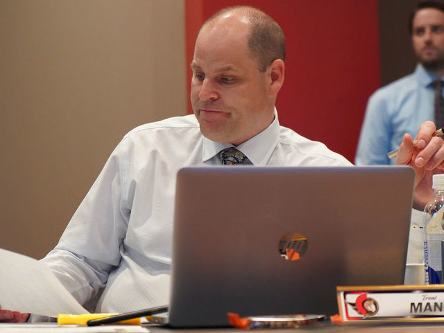 OTTAWA, CANADA - JULY 24: Chief Amateur Scout Trent Mann of the Ottawa Senators looks at his notes during rounds 2-7 of the 2021 NHL Entry Draft at Canadian Tire Centre on July 24, 2021 in Ottawa, Ontario, Canada.