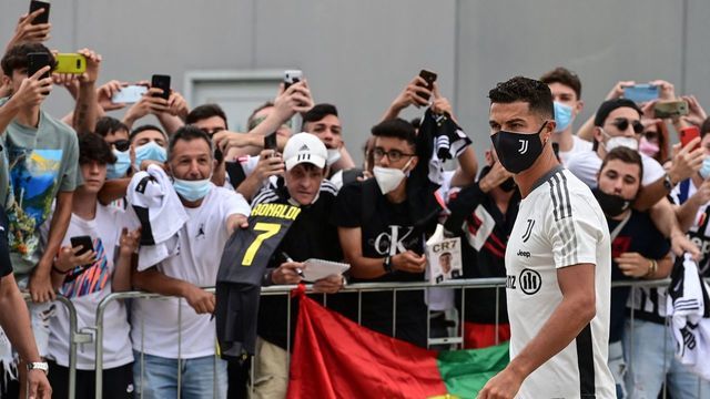 Juventus' Portuguese forward Cristiano Ronaldo is greeted by fans as he arrives for his medical examination at the Juventus medical center in Turin, on July 26, 2021.