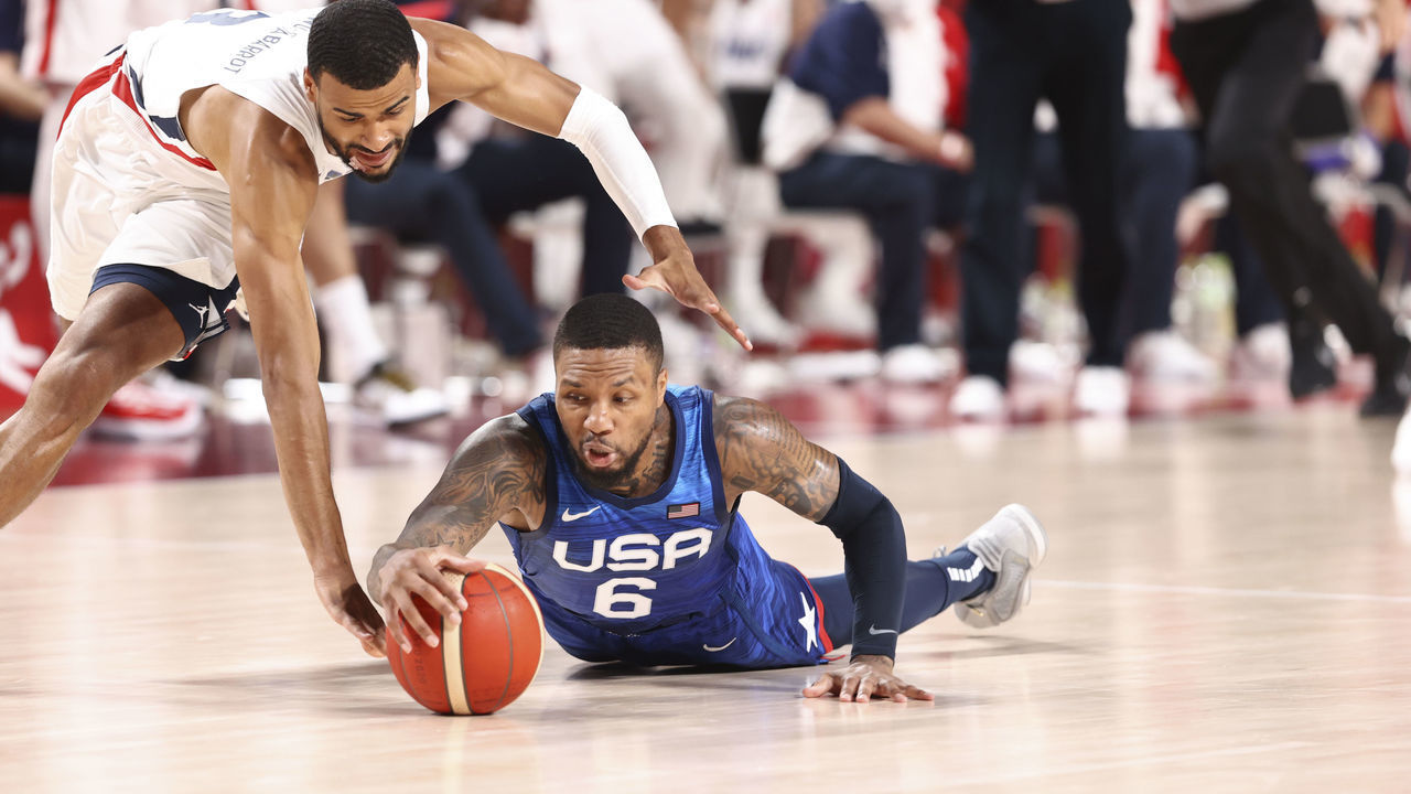TOKYO, JAPAN - JULY 25: Timothe Luwawu-Cabarrot #3 of the France Men's National Team and Damian Lillard #6 of the USA Men's National Team fight for possession during the 2020 Tokyo Olympics at the Saitama Super Arena on July 25, 2021 in Tokyo, Japan. NOTE TO USER: User expressly acknowledges and agrees that, by downloading and/or using this Photograph, user is consenting to the terms and conditions of the Getty Images License Agreement. Mandatory Copyright Notice: Copyright 2021 NBAE