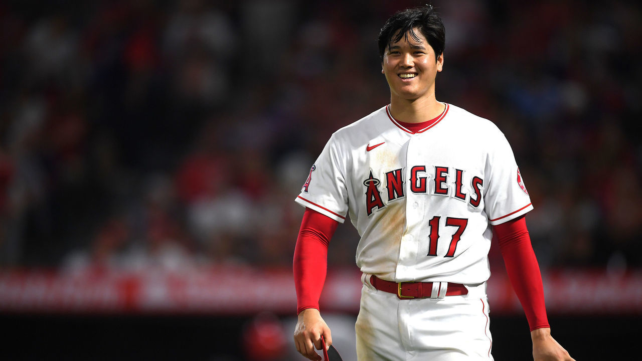 ANAHEIM, CA - JULY 26: Shohei Ohtani #17 of the Los Angeles Angels smiles at the umpires waiting to check his glove and hat after the sixth inning of the game against the Colorado Rockies at Angel Stadium of Anaheim on July 26, 2021 in Anaheim, California.