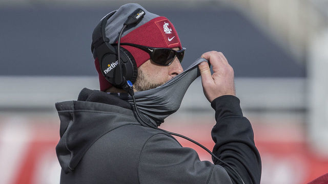 SALT LAKE CITY, UT - DECEMBER 19: Nick Rolovich head coach of the Washington State Cougars adjusts his mask during their game against the Utah Utes on December 19, 2020 at Rice Eccles Stadium in Salt Lake City, Utah.