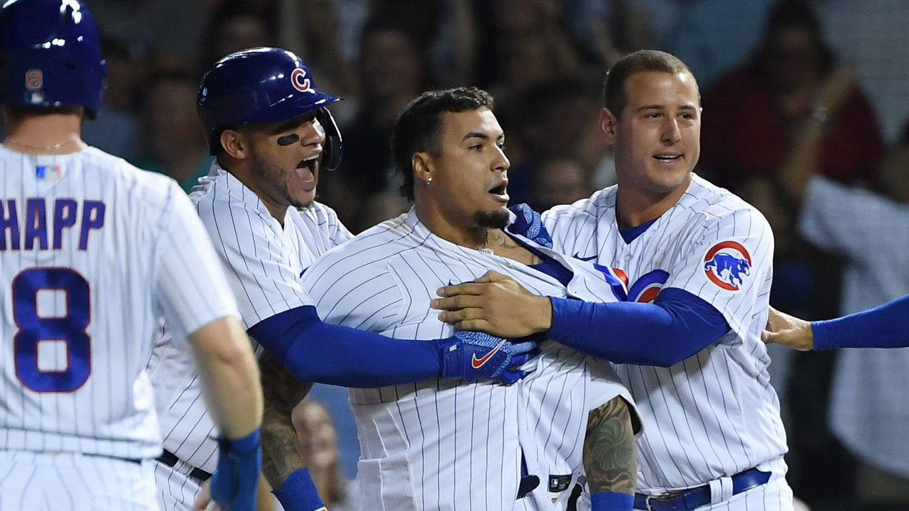 CHICAGO, ILLINOIS - JULY 26: Javier Baez #9 of the Chicago Cubs celebrates with teammates after his walk off single in the ninth inning against the Cincinnati Reds at Wrigley Field on July 26, 2021 in Chicago, Illinois.