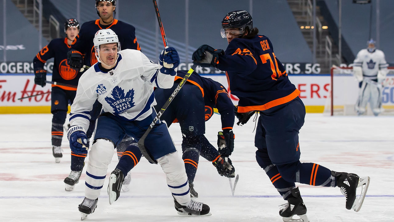 EDMONTON, AB - JANUARY 28: Ethan Bear #74 of the Edmonton Oilers battles against Zach Hyman #11 of the Toronto Maple Leafs at Rogers Place on January 28, 2021 in Edmonton, Canada.