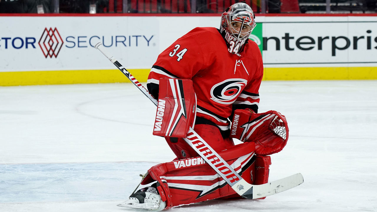 RALEIGH, NC - MAY 6: Petr Mrazek #34 of the Carolina Hurricanes deflects a puck away from the crease during an NHL game against the Chicago Blackhawks on May 6, 2021 at PNC Arena in Raleigh, North Carolina.