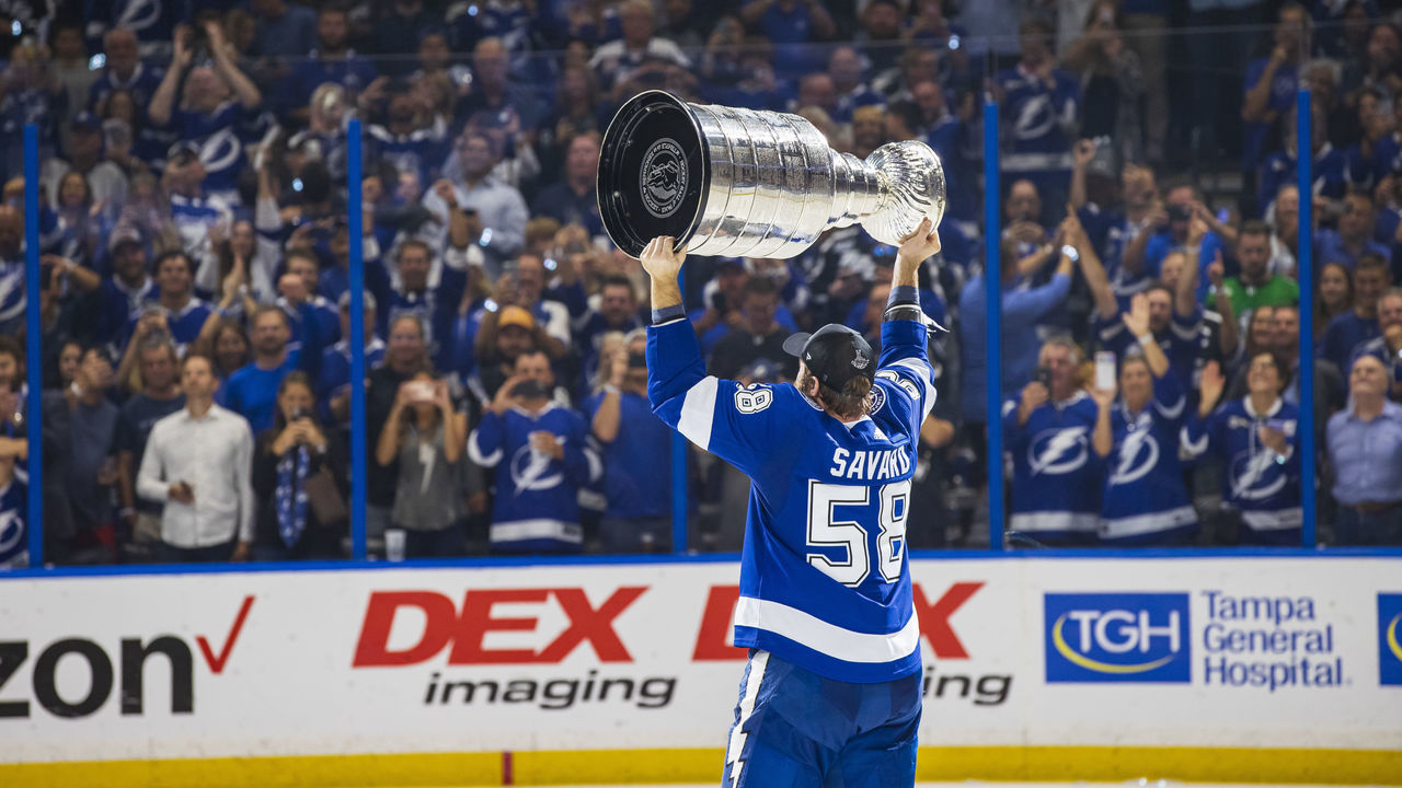 TAMPA, FL - JULY 7: David Savard #58 of the Tampa Bay Lightning hoists the Stanley Cup overhead after the Tampa Bay Lightning defeated the Montreal Canadiens in Game Five to win the best of seven game series 4-1 during the Stanley Cup Final of the 2021 Stanley Cup Playoffs at Amalie Arena on July 7, 2021 in Tampa, Florida.