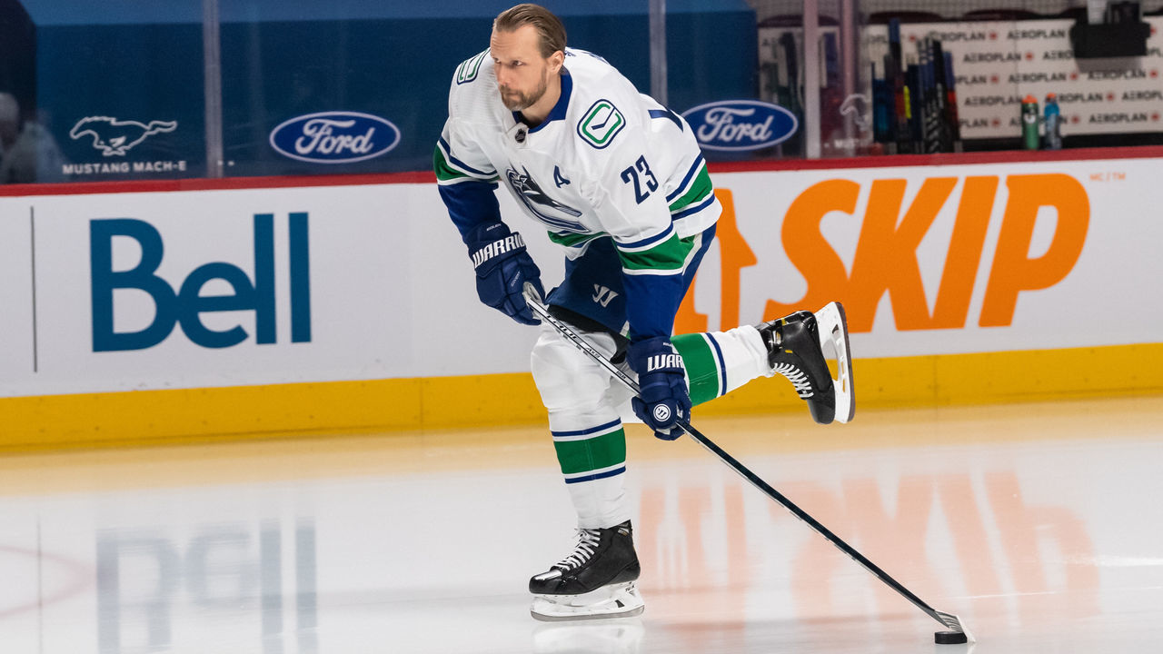 MONTREAL, QC - MARCH 20: Alexander Edler (23) of the Vancouver Canucks shoots the puck during the warmup period of the NHL game between the Vancouver Canucks and the Montreal Canadiens on March 20, 2021, at the Bell Centre in Montreal, QC