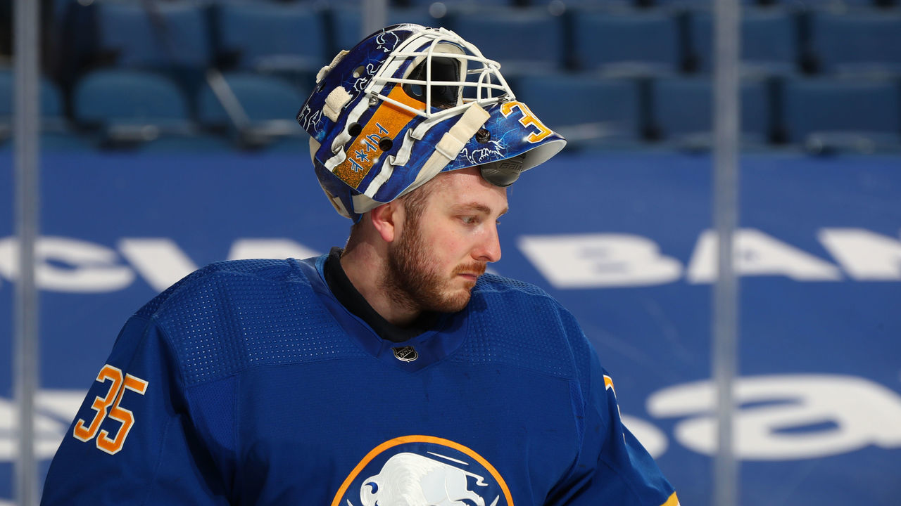 BUFFALO, NY - APRIL 8: Linus Ullmark #35 of the Buffalo Sabres takes a break against the New Jersey Devils during an NHL game on April 8, 2021 at KeyBank Center in Buffalo, New York.