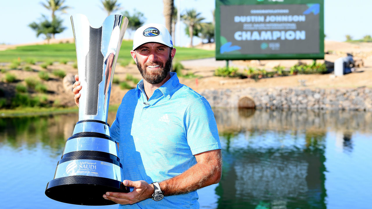 KAEC, SAUDI ARABIA - FEBRUARY 07: Dustin Johnson of the USA with the winners trophy after the final round of the Saudi International powered by SoftBank Investment Advisers at Royal Greens Golf and Country Club on February 07, 2021 in King Abdullah Economic City, Saudi Arabia.