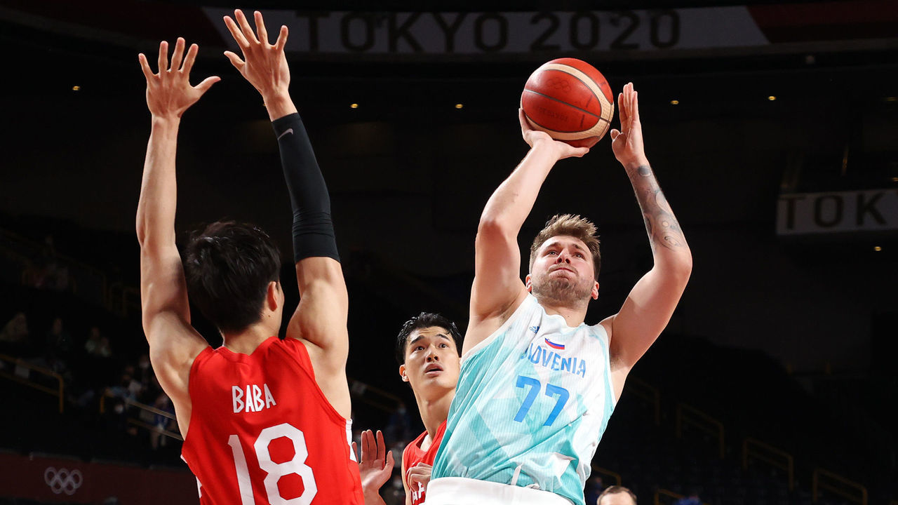 SAITAMA, JAPAN - JULY 29: Luka Doncic #77 of Team Slovenia shoots against Yudai Baba #18 of Team Japan during the first half of a Men's Preliminary Round Group C game on day six of the Tokyo 2020 Olympic Games at Saitama Super Arena on July 29, 2021 in Saitama, Japan.