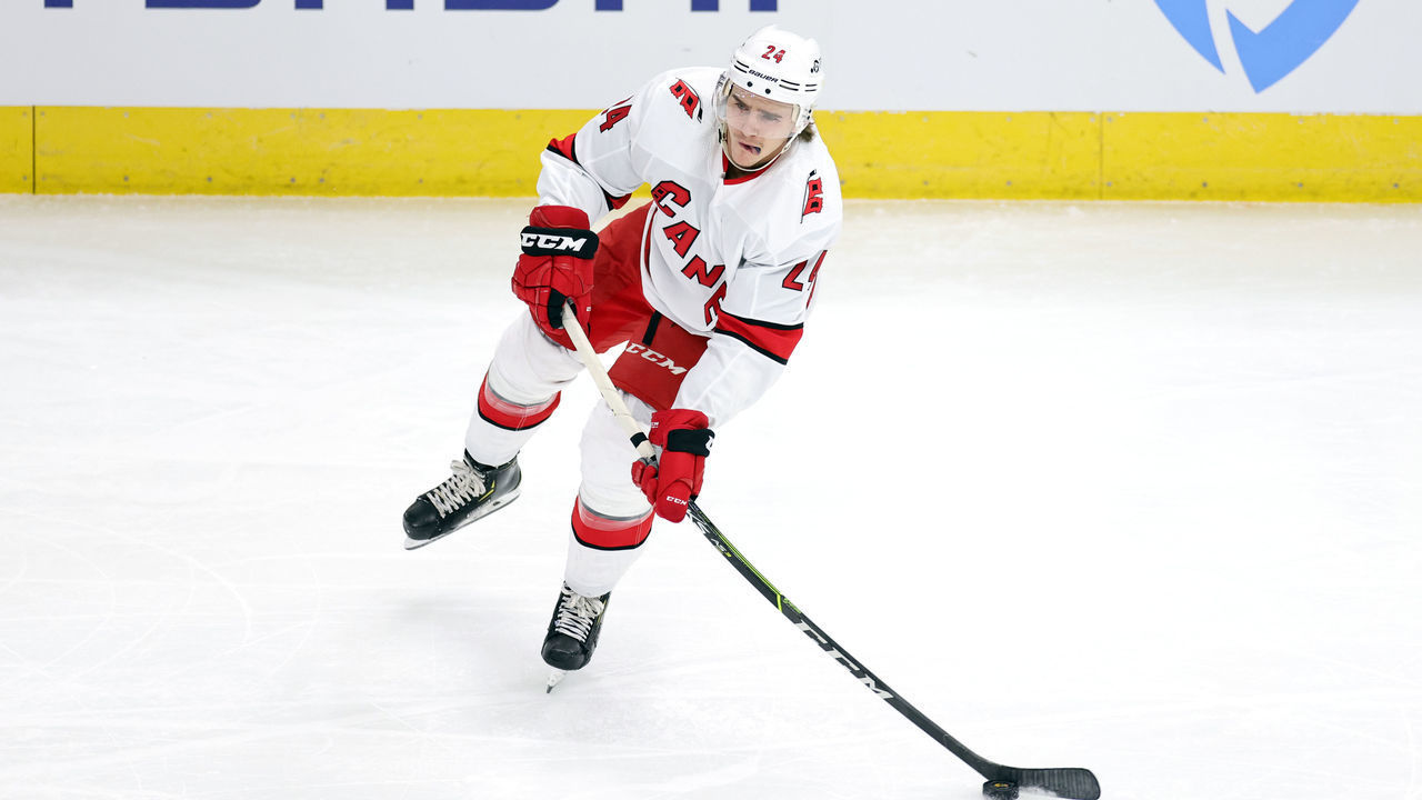CHICAGO, IL - APRIL 01: Carolina Hurricanes defenseman Jake Bean (24) skates with the puck in action during a game between the Chicago Blackhawks and the Carolina Hurricanes on April 01, 2021 at the United Center in Chicago, IL.