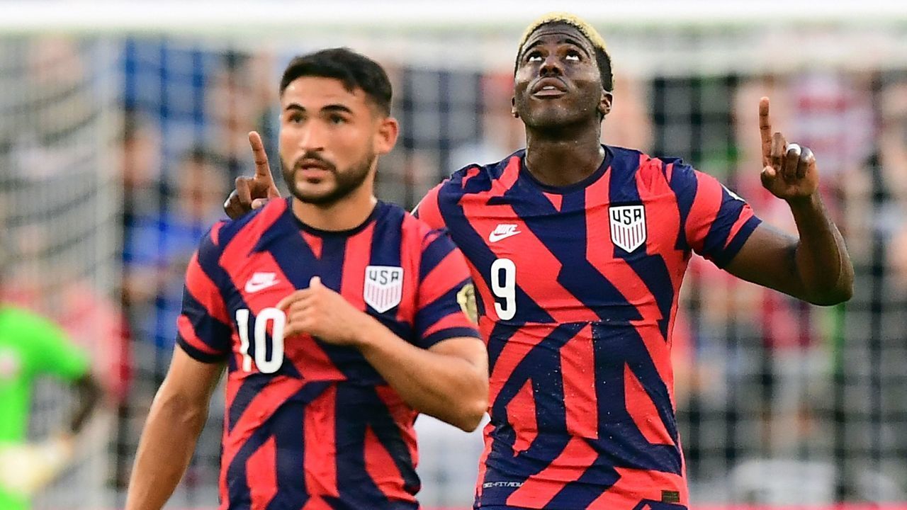 USA's Gyasi Zardes (R) and Cristian Roldan (L) celbrate after scoring during the Concacaf Gold Cup semifinal football match between Qatar and USA at Q2 stadium in Austin, Texas on July 29, 2021.
