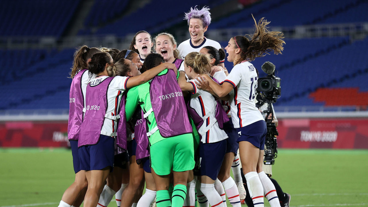 YOKOHAMA, JAPAN - JULY 30: Megan Rapinoe #15 of Team United States celebrates with Rose Lavelle #16 and team mates following their team's victory in the penalty shoot out during the Women's Quarter Final match between Netherlands and United States on day seven of the Tokyo 2020 Olympic Games at International Stadium Yokohama on July 30, 2021 in Yokohama, Kanagawa, Japan.