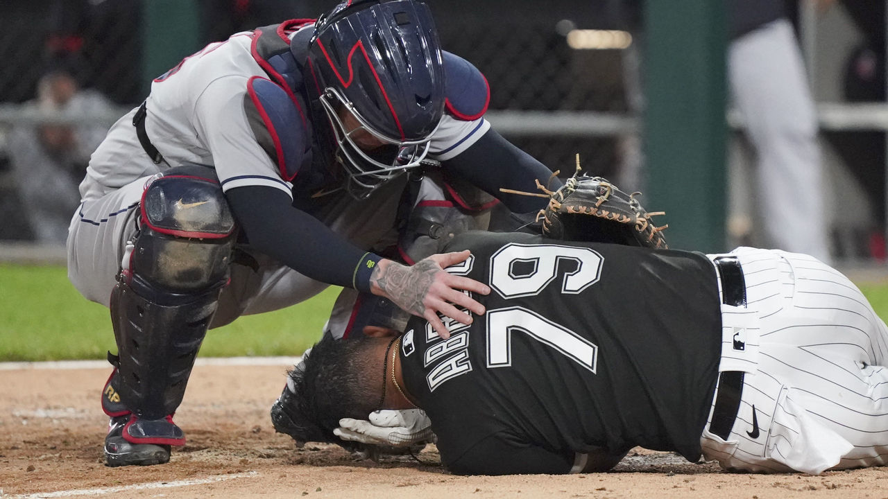 CHICAGO, ILLINOIS - JULY 30: Roberto Perez #55 of the Cleveland Indians checks on Jose Abreu #79 of the Chicago White Sox after he was hit by a pitch during the eighth inning of a game at Guaranteed Rate Field on July 30, 2021 in Chicago, Illinois.