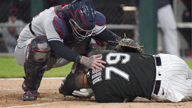 CHICAGO, ILLINOIS - JULY 30: Roberto Perez #55 of the Cleveland Indians checks on Jose Abreu #79 of the Chicago White Sox after he was hit by a pitch during the eighth inning of a game at Guaranteed Rate Field on July 30, 2021 in Chicago, Illinois.