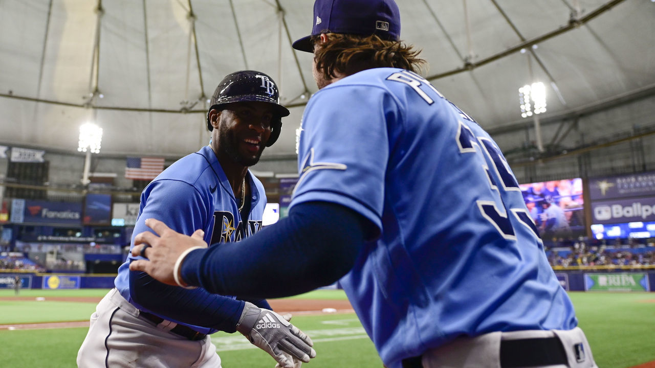 ST PETERSBURG, FLORIDA - JULY 30: Yandy Diaz #2 of the Tampa Bay Rays celebrates with Brett Phillips #35 after hitting a two run home run during the first inning against the Boston Red Sox at Tropicana Field on July 30, 2021 in St Petersburg, Florida.