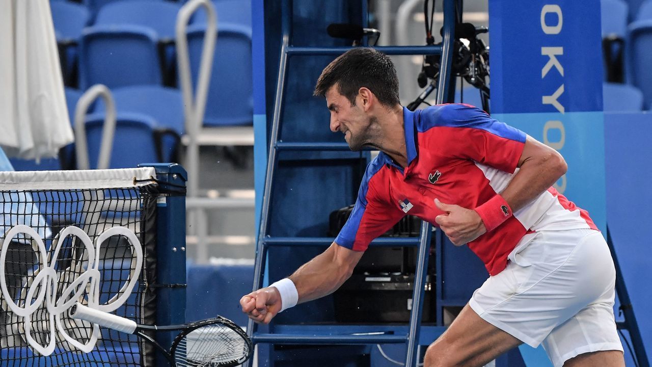 Serbia's Novak Djokovic smashes his racket during his Tokyo 2020 Olympic Games men's singles tennis match for the bronze medal against Spain's Pablo Carreno Busta at the Ariake Tennis Park in Tokyo on July 31, 2021.