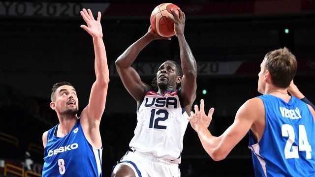 USA's Jrue Holiday takes a shot past Czech Republic's Tomas Satoransky (L) in the men's preliminary round group A basketball match between USA and Czech Republic during the Tokyo 2020 Olympic Games at the Saitama Super Arena in Saitama on July 31, 2021.