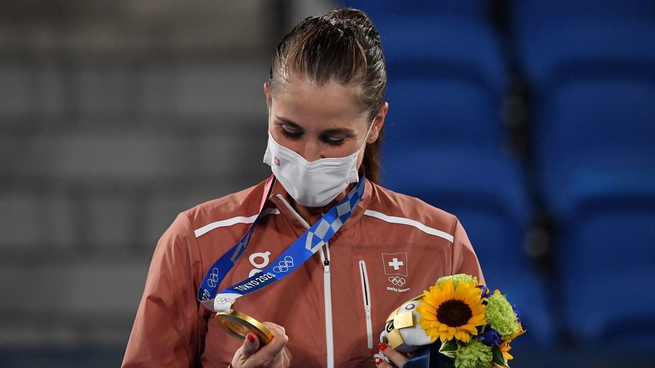Gold medallist Switzerland's Belinda Bencic looks at her medal during the Tokyo 2020 Olympic Games women's singles tennis medal ceremony at the Ariake Tennis Park in Tokyo on July 31, 2021.