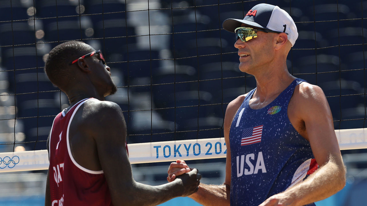 TOKYO, JAPAN - AUGUST 01: Philip Dalhausser #1 of Team United States speaks with Cherif Younousse #1 of Team Qatar after losing the match during the Men's Round of 16 beach volleyball on day nine of the Tokyo 2020 Olympic Games at Shiokaze Park on August 01, 2021 in Tokyo, Japan.