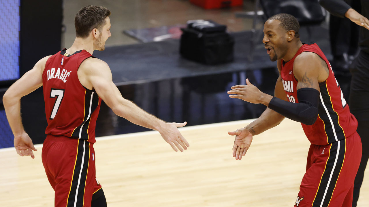 MIAMI, FLORIDA - DECEMBER 25: Goran Dragic #7 and Andre Iguodala #28 of the Miami Heat celebrate against the New Orleans Pelicans during the fourth quarter at American Airlines Arena on December 25, 2020 in Miami, Florida.