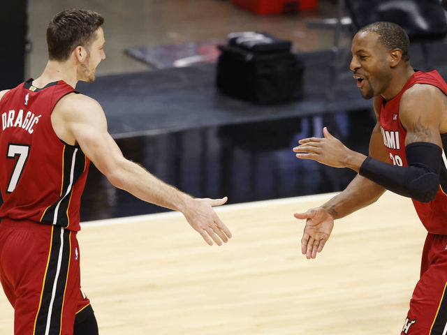 MIAMI, FLORIDA - DECEMBER 25: Goran Dragic #7 and Andre Iguodala #28 of the Miami Heat celebrate against the New Orleans Pelicans during the fourth quarter at American Airlines Arena on December 25, 2020 in Miami, Florida.