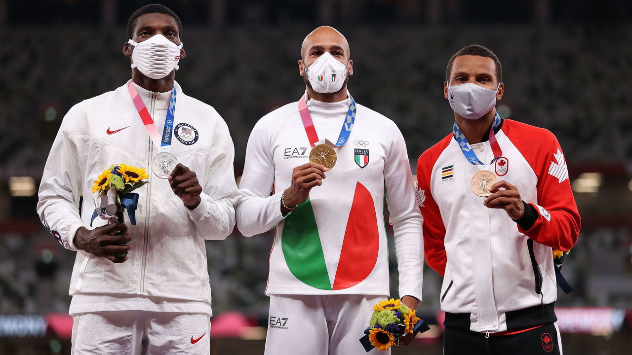 TOKYO, JAPAN - AUGUST 02: (L-R) Silver medalist Fred Kerley of Team USA, gold medalist Lamont Marcell Jacobs of Team Italy and bronze medalist Andre De Grasse of Team Canada hold their medals on the podium during the medal ceremony for the Men's 100m on day ten of the Tokyo 2020 Olympic Games at Olympic Stadium on August 02, 2021 in Tokyo, Japan.