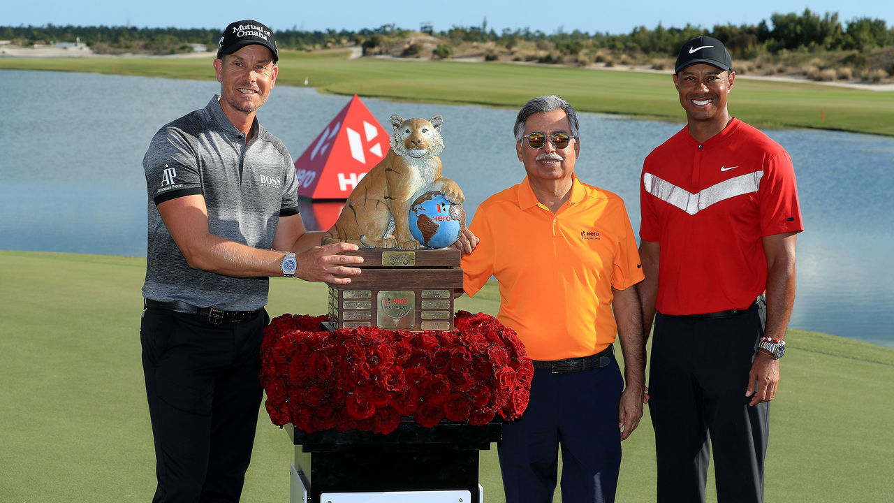 NASSAU, BAHAMAS - DECEMBER 07: Tiger Woods of the United States the tournament host and Dr Pawan Munjal present Henrik Stenson of Sweden with the trophy after the final round of the 2019 Hero World Challenge at Albany on December 07, 2019 in Nassau, Bahamas.