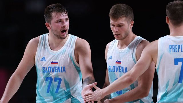 Slovenia's Luka Doncic (L) celebrates with teammates after their win in the men's quarter-final basketball match between Slovenia and Germany during the Tokyo 2020 Olympic Games at the Saitama Super Arena in Saitama on August 3, 2021.