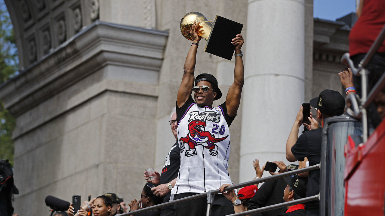 TORONTO, ON - JUNE 17: Kyle Lowry #7 of the Toronto Raptors holds the Larry O'Brien Championship Trophy on the team bus during the Toronto Raptors Championship Victory Parade on June 17, 2019 in Toronto, Ontario. NOTE TO USER: User expressly acknowledges and agrees that, by downloading and/or using this photograph, user is consenting to the terms and conditions of Getty Images License Agreement. Mandatory Copyright Notice: Copyright 2019 NBAE