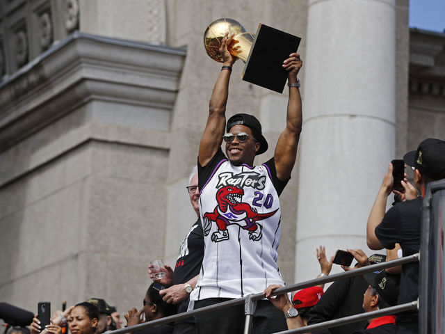 TORONTO, ON - JUNE 17: Kyle Lowry #7 of the Toronto Raptors holds the Larry O'Brien Championship Trophy on the team bus during the Toronto Raptors Championship Victory Parade on June 17, 2019 in Toronto, Ontario. NOTE TO USER: User expressly acknowledges and agrees that, by downloading and/or using this photograph, user is consenting to the terms and conditions of Getty Images License Agreement. Mandatory Copyright Notice: Copyright 2019 NBAE