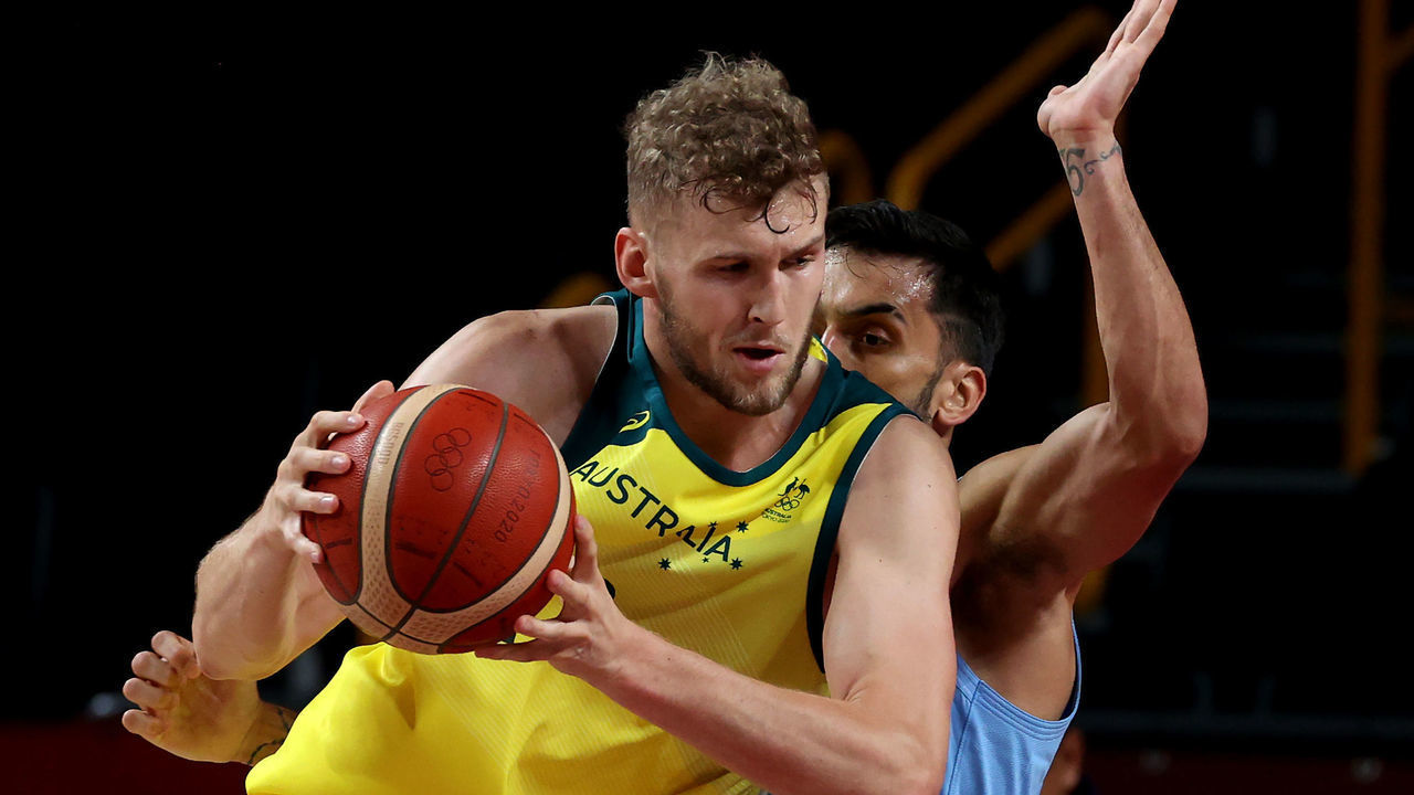 SAITAMA, JAPAN - AUGUST 03: Jock Landale #13 of Team Australia drives to the basket against Facundo Campazzo #7 of Team Argentina during the first half of a Men's Basketball Quarterfinal game on day eleven of the Tokyo 2020 Olympic Games at Saitama Super Arena on August 03, 2021 in Saitama, Japan.