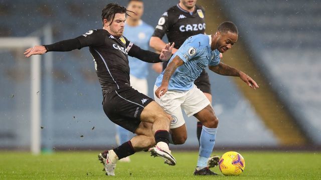 Aston Villa's English midfielder Jack Grealish (L) challenges Manchester City's English midfielder Raheem Sterling (R) during the English Premier League football match between Manchester City and Aston Villa at the Etihad Stadium in Manchester, north west England, on January 20, 2021.