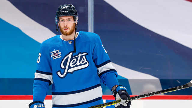WINNIPEG, MB - MARCH 17: Pierre-Luc Dubois #13 of the Winnipeg Jets looks on during the pre-game warm up prior to NHL action against the Montreal Canadiens at the Bell MTS Place on March 17, 2021 in Winnipeg, Manitoba, Canada.