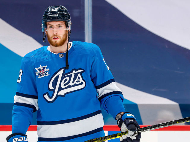 WINNIPEG, MB - MARCH 17: Pierre-Luc Dubois #13 of the Winnipeg Jets looks on during the pre-game warm up prior to NHL action against the Montreal Canadiens at the Bell MTS Place on March 17, 2021 in Winnipeg, Manitoba, Canada.