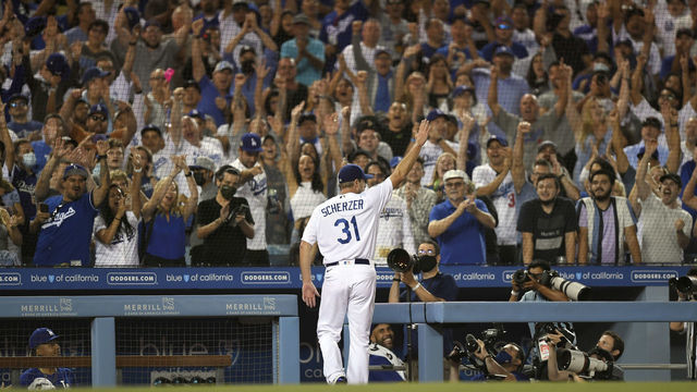 LOS ANGELES, CA - AUGUST 04: Starting pitcher Max Scherzer #31 of the Los Angeles Dodgers gets a curtain call after pitching seven innings in his Dodger debut at Dodger Stadium on August 4, 2021 in Los Angeles, California.