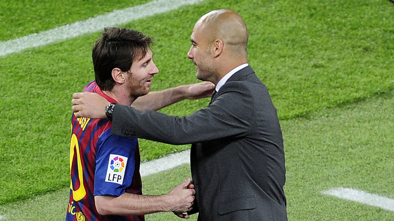 Barcelona's Argentinian forward Lionel Messi (L) celebrates with Barcelona's coach Josep Guardiola after scoring a goal during the Spanish league football match FC Barcelona vs RCD Espanyol on May 5, 2012 at the Camp Nou stadium in Barcelona. AFP PHOTO/ JOSEP LAGO