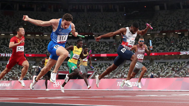 TOKYO, JAPAN - AUGUST 06: Filippo Tortu of Team Italy beats Nethaneel Mitchell-Blake of Team Great Britain across the finish line to win the gold medal in the Men's 4 x 100m Relay Final on day fourteen of the Tokyo 2020 Olympic Games at Olympic Stadium on August 06, 2021 in Tokyo, Japan.