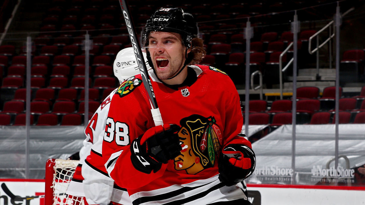 CHICAGO, ILLINOIS - APRIL 01: Brandon Hagel #38 of the Chicago Blackhawks celebrates after scoring a goal in the third period against the Carolina Hurricanes at the United Center on April 01, 2021 in Chicago, Illinois.