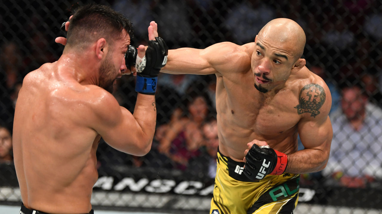 HOUSTON, TEXAS - AUGUST 07: (R-L) Jose Aldo of Brazil punches Pedro Munhoz of Brazil in their bantamweight bout during the UFC 265 event at Toyota Center on August 07, 2021 in Houston, Texas.