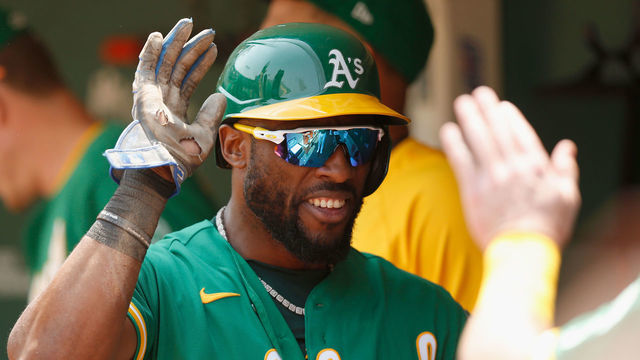 OAKLAND, CALIFORNIA - AUGUST 07: Starling Marte #2 of the Oakland Athletic celebrates in the dugout after scoring on a two-run double by Mark Canha #20 in the bottom of the third inning against the Texas Rangers at RingCentral Coliseum on August 07, 2021 in Oakland, California.