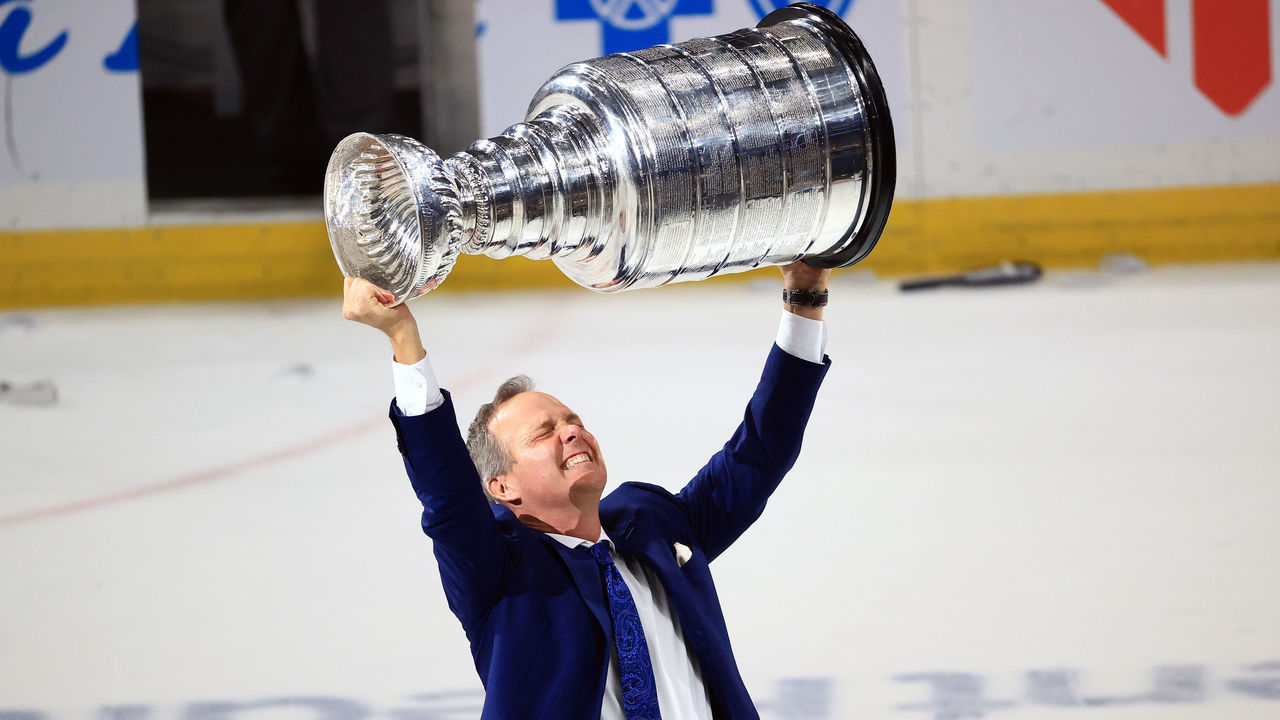 TAMPA, FLORIDA - JULY 07: Head coach Jon Cooper of the Tampa Bay Lightning hoists the Stanley Cup after the 1-0 victory against the Montreal Canadiens in Game Five to win the 2021 NHL Stanley Cup Final at Amalie Arena on July 07, 2021 in Tampa, Florida.