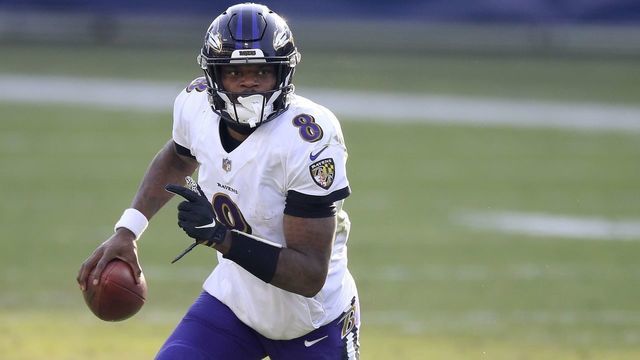 NASHVILLE, TENNESSEE - JANUARY 10: Lamar Jackson #8 of the Baltimore Ravens runs with the ball against the Tennessee Titans in the Wild Card Round of the NFL Playoffs at Nissan Stadium on January 10, 2021 in Nashville, Tennessee.