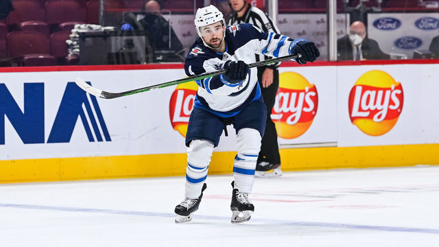 MONTREAL, QC - JUNE 07: Winnipeg Jets defenceman Neal Pionk (4) passes the puck during the NHL Stanley Cup Playoffs second round game 4 between the Winnipeg Jets versus the Montreal Canadiens on June 07, 2021, at Bell Centre in Montreal, QC