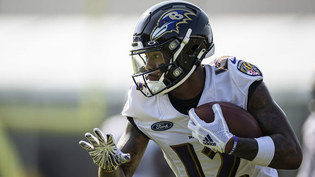 OWINGS MILLS, MD - JULY 28: Rashod Bateman #12 of the Baltimore Ravens participates in a drill during training camp at Under Armour Performance Center Baltimore Ravens on July 28, 2021 in Owings Mills, Maryland.