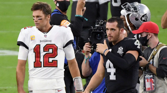 LAS VEGAS, NEVADA - OCTOBER 25: Quarterback Tom Brady #12 of the Tampa Bay Buccaneers and quarterback Derek Carr #4 of the Las Vegas Raiders walk off the field after their game at Allegiant Stadium on October 25, 2020 in Las Vegas, Nevada. The Buccaneers defeated the Raiders 45-20.