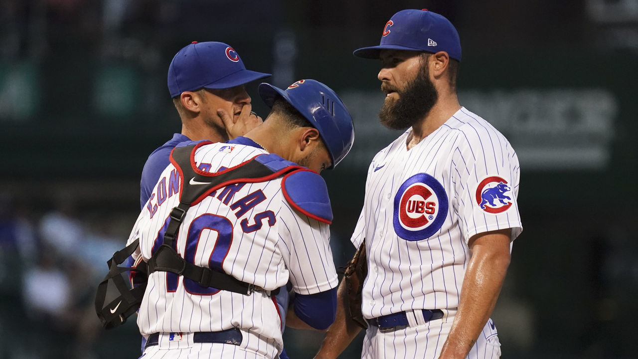 CHICAGO, ILLINOIS - AUGUST 11: Pitching coach Tommy Hottovy #68 of the Chicago Cubs visits the mound to speak with Jake Arrieta #49 in the first inning against the Milwaukee Brewers at Wrigley Field on August 11, 2021 in Chicago, Illinois.