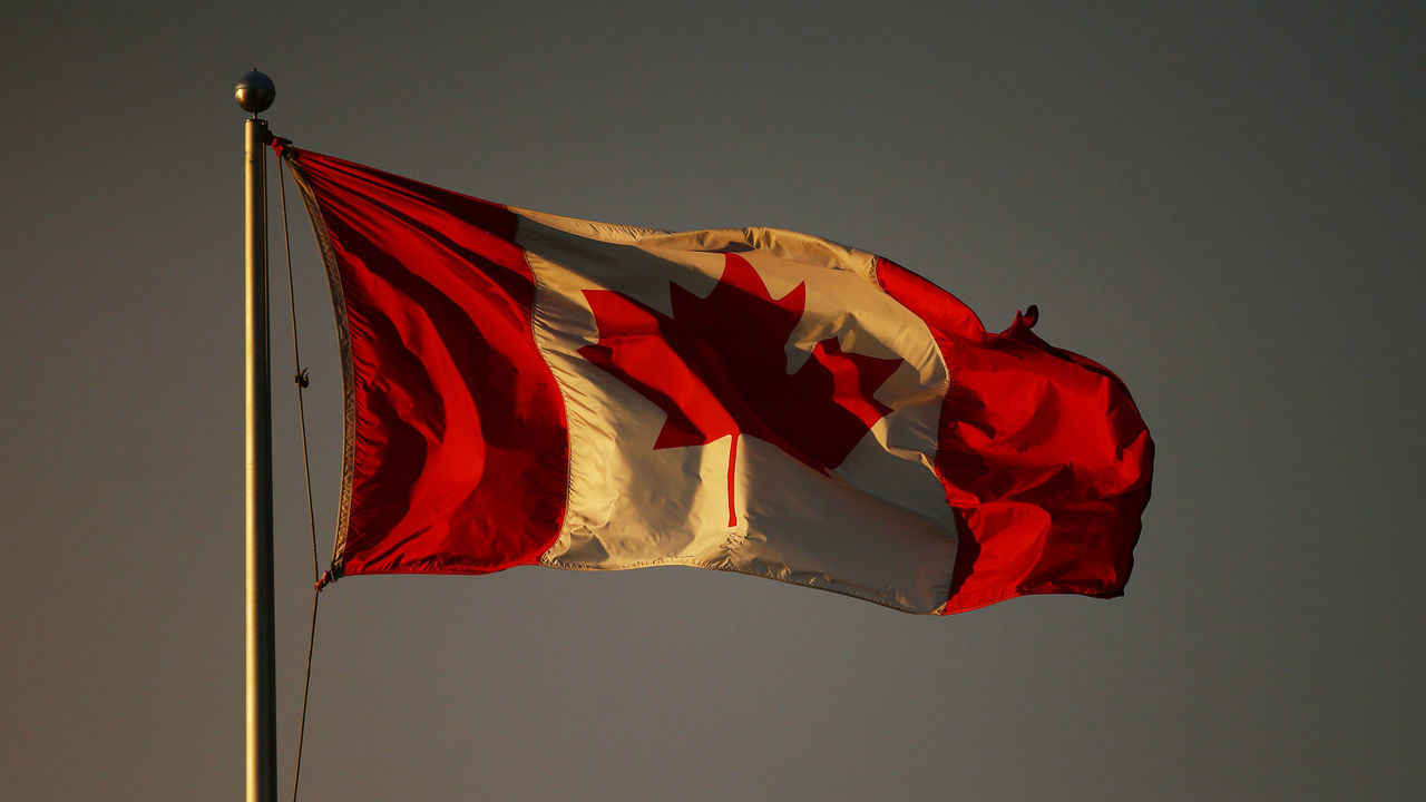 TORONTO, ON - AUGUST 10: A Canadian flag flutters in the late evening light above Centre Court on Day Two of the National Bank Open at Aviva Centre on August 10, 2021 in Toronto, Ontario, Canada.