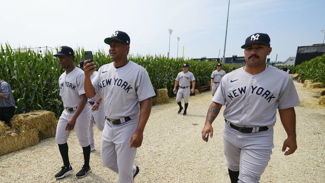 DYERSVILLE, IL - AUGUST 12: Members of the New York Yankees are seen walking to the field before the game between the New York Yankees and the Chicago White Sox at MLB Field at Field of Dreams on Thursday, August 12, 2021 in Dyersville, Iowa.