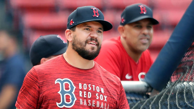 Boston, MA - August 10: New Red Sox player Kyle Schwarber around the cage during batting practice, left, with manager Alex Cora in the background. The Boston Red Sox hosted the Tampa Bay Rays in a regular season MLB baseball game at Fenway Park in Boston on August 10, 2021.