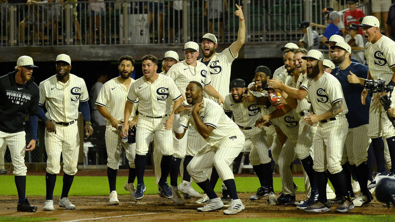 CHICAGO - AUGUST 12: Members of the Chicago White Sox celebrate at home plate after Tim Anderson #7 of the Chicago White Sox hit a game winning, walk-off home run in the ninth inning against the New York Yankees on August 12, 2021 at Field of Dreams in Dyersville, Iowa.